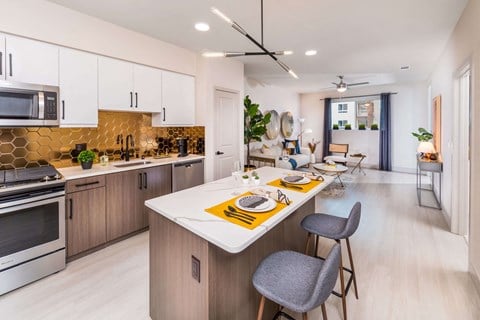 bronze finish model kitchen with sleek appliances at Avel Apartment Homes in Orange CA